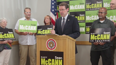 State Senator and 4th district Congressional candidate Sean McCann (center) speaks during a press event at the local offices of the International Brotherhood of Electrical Workers 131 on Friday, August 28, 2026. He was joined by constituents and supporters — as well as IBEW 131 assistant business manager Jonathan Current and former state representative David Maturen, who spoke in his support.