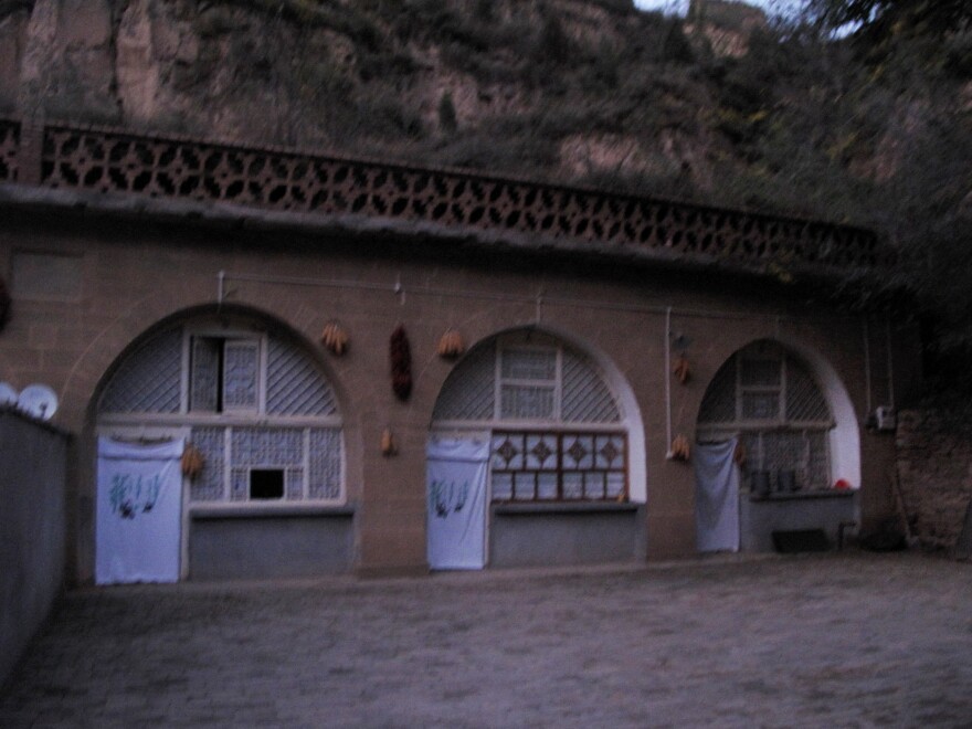 Xi lived in the cave house on the far right, in Liangjiahe village in central China. After his father's political downfall in Beijing, his parents sent him there when he was 15 in 1968.