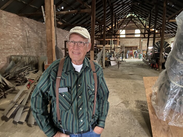 Doug Schoenhals standing inside one of the Museum's storage/workshop buildings