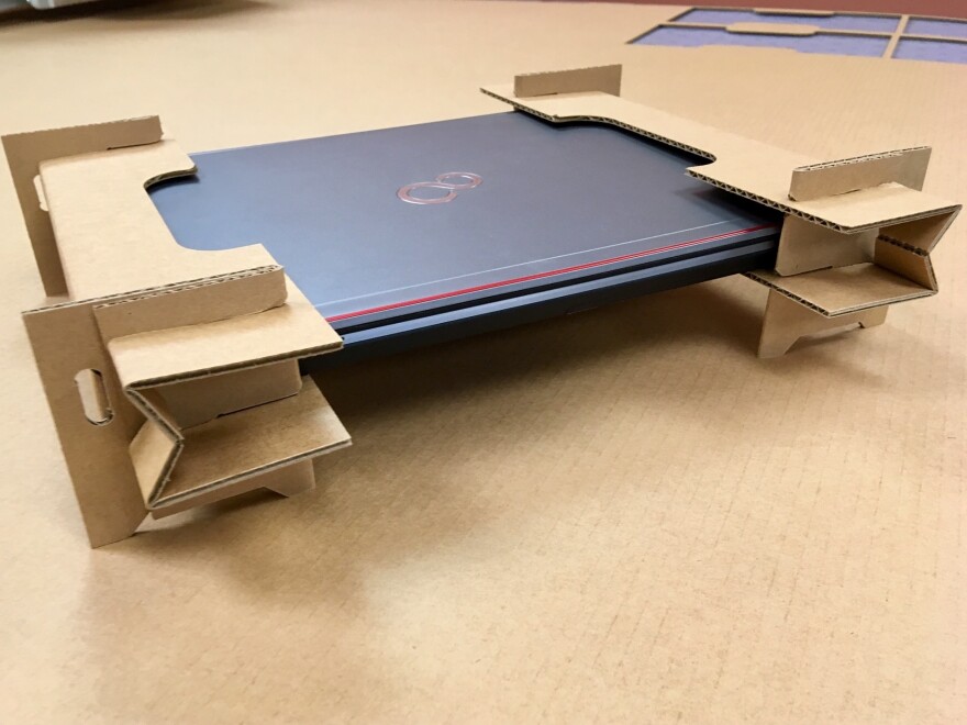 These cardboard cutouts are designed to replace the plastic foam end caps companies use to ship laptop computers.