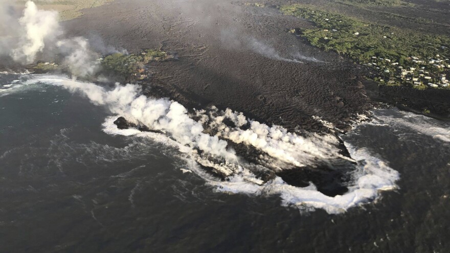Lava enters the ocean at Kapoho Bay, Hawaii, on Tuesday. A U.S. Geological Survey morning overflight confirmed that lava had completely filled the bay.