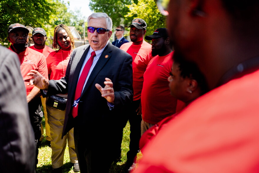 Missouri Gov. Mike Parson talks to members of the Urban League's "Serving Our Streets" initiative on Tuesday, June 28, 2022, while visiting north St. Louis as part of a legislative wins tour. Parson allocated $1 million for the initiative in 2020.