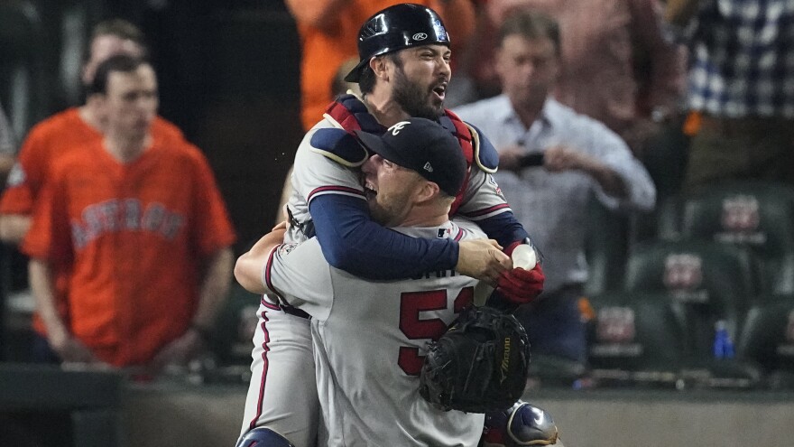 Atlanta Braves relief pitcher Will Smith and catcher Travis d'Arnaud celebrate after winning baseball's World Series in Game 6 against the Houston Astros Tuesday, in Houston. The Braves won 7-0.