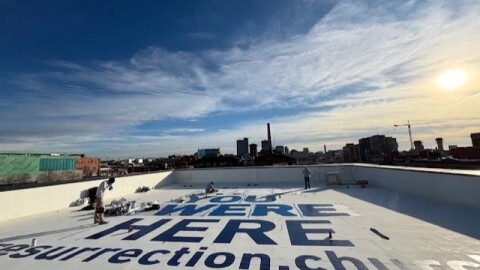 The United Methodist Church of the Resurrection has splashed a large welcome sign for World Cup athletes and fans on the roof of its campus in downtown Kansas City. It can be seen from airplanes and from nearby tall buildings and is part of the way this 10-campus church is readying for this summer’s World Cup competition in Kansas City.