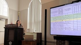  Jenna Carroll, director of education at the Historical Society of Cheshire County, speaks about research into the lives of the Monadnock Region's Black residents in previous centuries during a presentation in Keene on Monday. The slide shows a record from the 1870 census with an entry for Phoebe Simmons, a Black domestic servant who was enslaved for part of her life, highlighted in yellow.