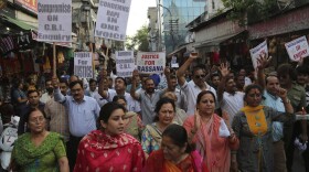 Indians carry placards and march in a rally demanding the investigation into the rape and murder of an 8-year-old girl be handed over to the Central Bureau of Investigation (CBI), in Jammu, India, Thursday, April 19, 2018. (Channi Anand/AP)