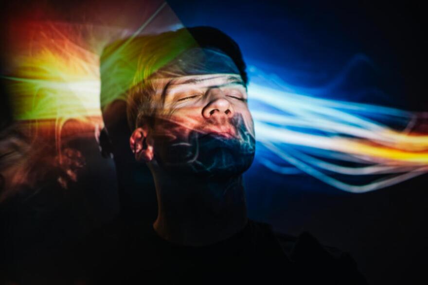 Portrait of a man and neon projection of abstract lines on his face. (Tatiana Maksimova/Getty Images)