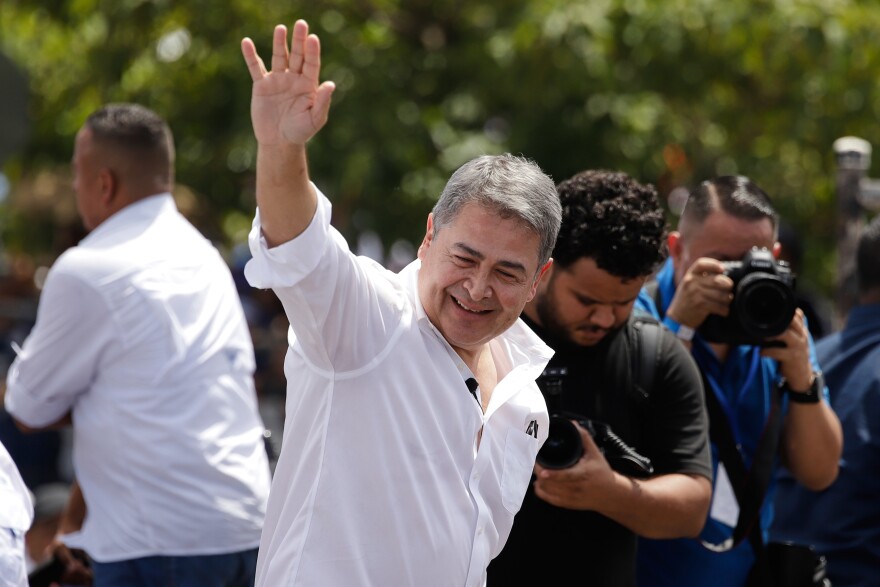 Former Honduran President Juan Orlando Hernández waves after his arrival to Toncontin airport