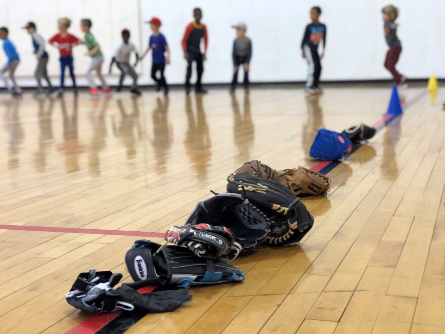 Kids do calisthenics before starting a baseball clinic in Washington, D.C.