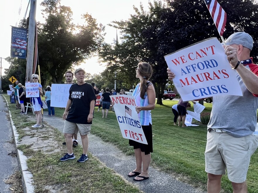 Yarmouth residents and others who object to the state sending migrants to the town demonstrated outside Tuesday's meeting of the Yarmouth Board of Selectmen.