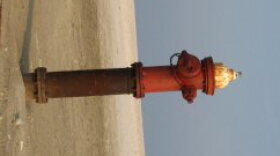 A fire hydrant stands as a stark reminder of Dauphin Island's massive erosion.