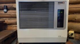 A white stove in a log cabin
