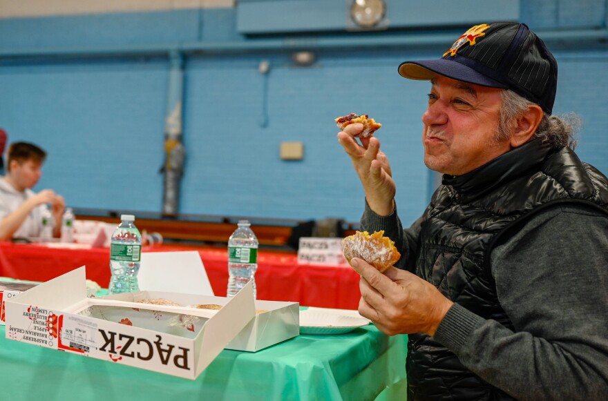 Joe Cassetti, an Ansonia alderman, eats paczki during Tuesday's competition. Paczki are a traditional jelly-filled dpnut eaten on Fat Tuesday as a last indulgence before Lent. 