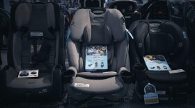 Multiple car seats on display at a box store.