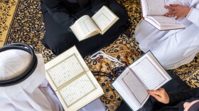 Overhead view of Muslim family members reading the quraan together