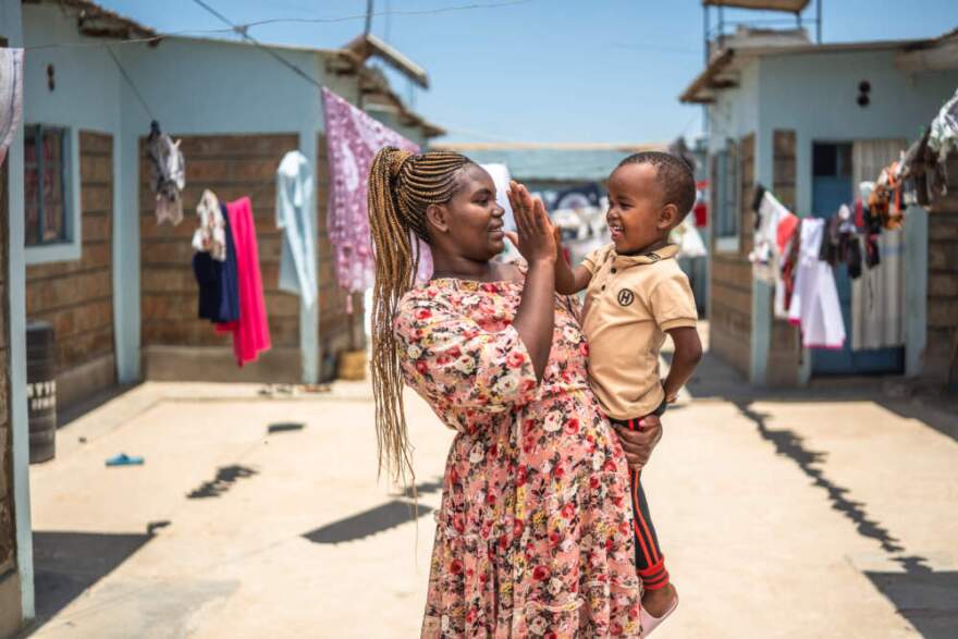 Christine and her son at their home in Wote, Makueni County, Kenya, on March 14, 2025. Makueni County has implemented E-MOTIVE (Early Detection and Treatment of Postpartum Hemorrhage), which is focused on reducing maternal deaths from postpartum hemorrhage (PPH), a major cause of maternal mortality. (Courtesy of Brian Otieno/Gates Foundation)