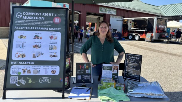 Green Michigan Executive Director Angela Fox at her composting booth at the Muskegon Farmers Market