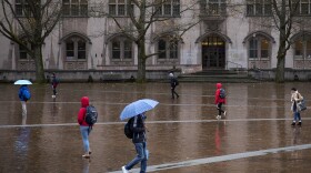 Students walk in front of Gerberding Hall on Thursday, November 16, 2017, on the University of Washington campus in Seattle. 