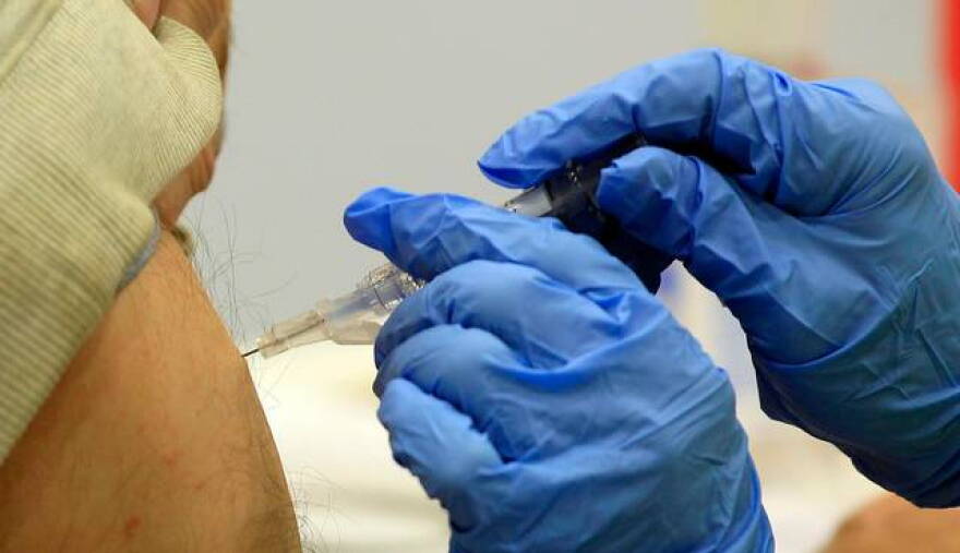 A client recieves a flu shot