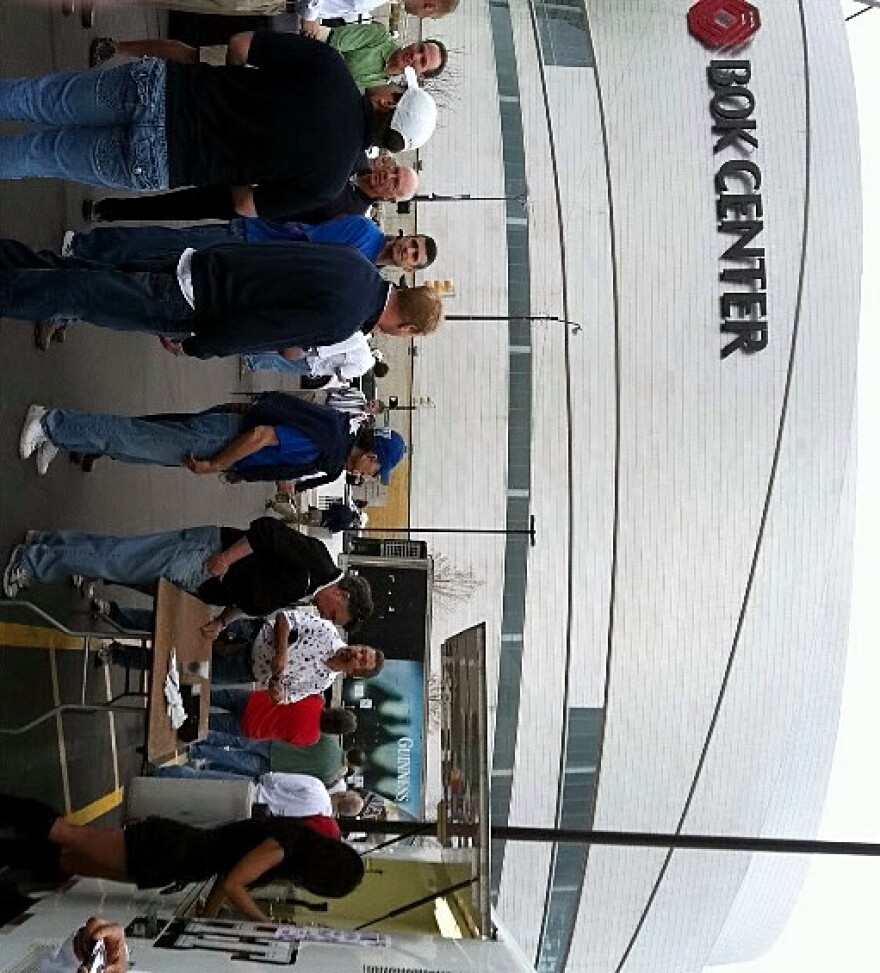 People wait in the beer line across the street from the BOK Center