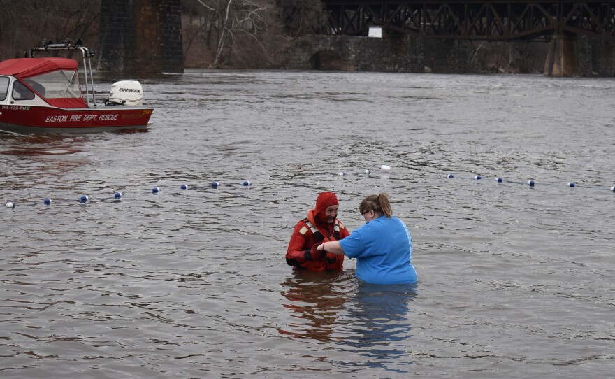 Easton Volunteer Fire officer helping a plunger into the water