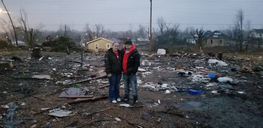 Terra Utley and her partner Jeremiah Barker stand on the land where the home once stood before the December 10, 2021 tornadoes.