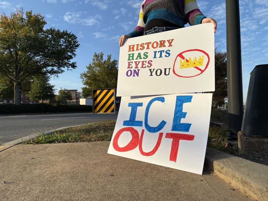 A voter holds a sign outside President Donald Trump's rally in Rock Hill, South Carolina, on Thursday, Oct. 29, 2026.