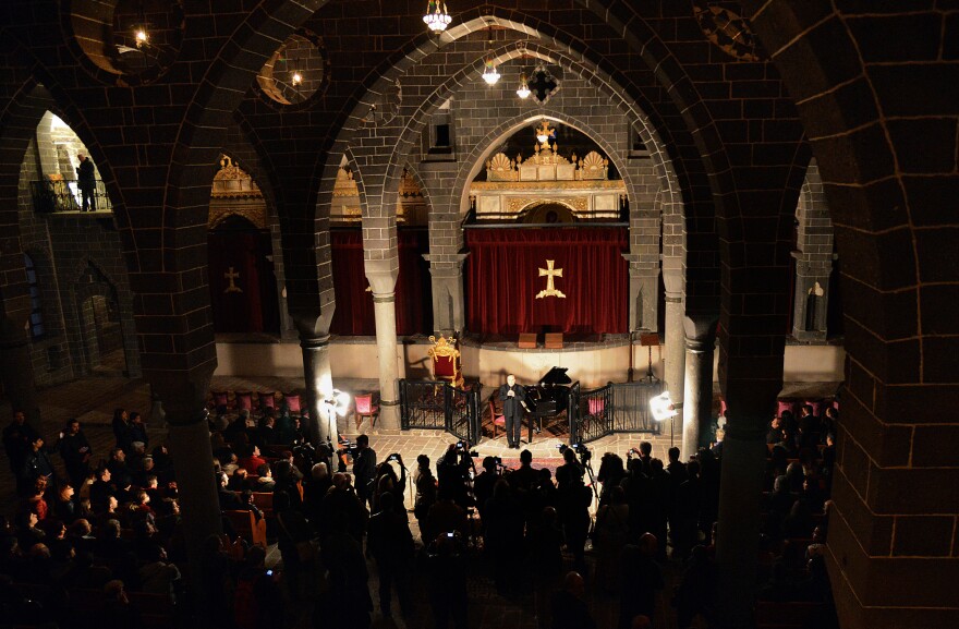 People attend a concert by Armenian pianist Raffi Bedrosya at St. Grigaros Church in Diyarbakir on Thursday. The event marked the 100th anniversary of the massacre of an estimated 1.5 million Armenians by Ottoman forces.