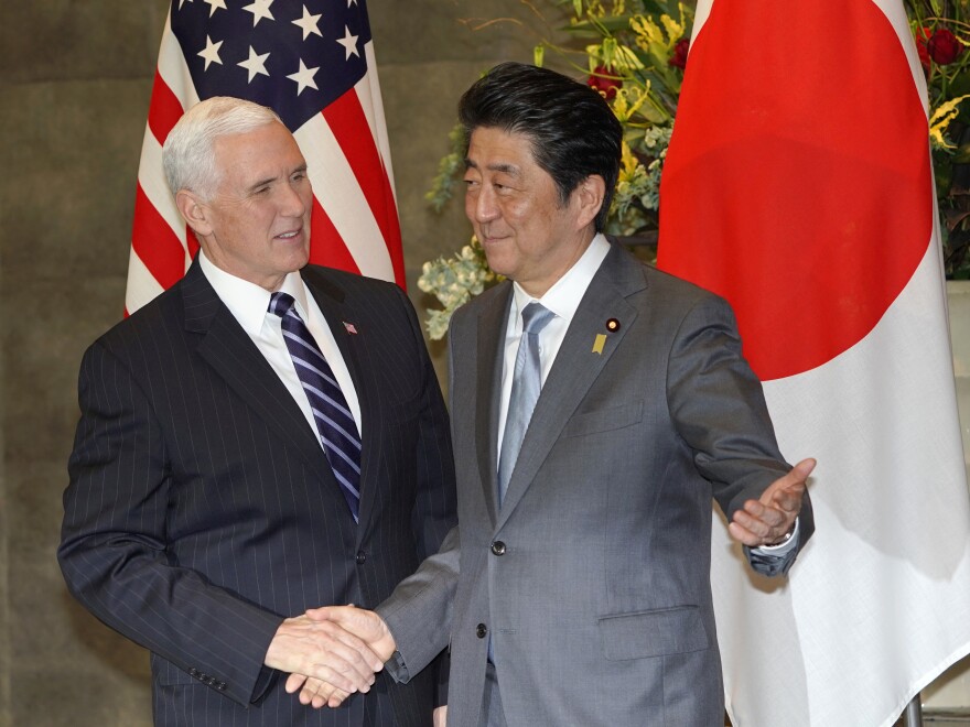 Vice President Pence is greeted by Japanese Prime Minister Shinzo Abe in Tokyo on Wednesday.