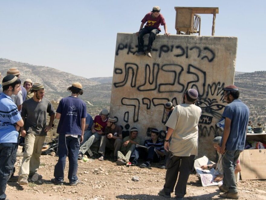 Jewish settlers, known as the Hilltop Youth, gather at an outpost at Itamar in the West Bank on Sept. 8, 2011. The youths were standing watch to see if Israeli security forces were coming to demolish the outpost.