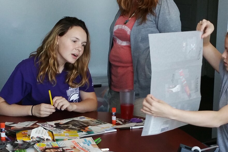 Kelsey Wasser (left) and Dawn Carson, street outreach supervisor (right), look at the artwork of one of the juveniles at the Homeward Bound Emergency Shelter in Covington, Ky.