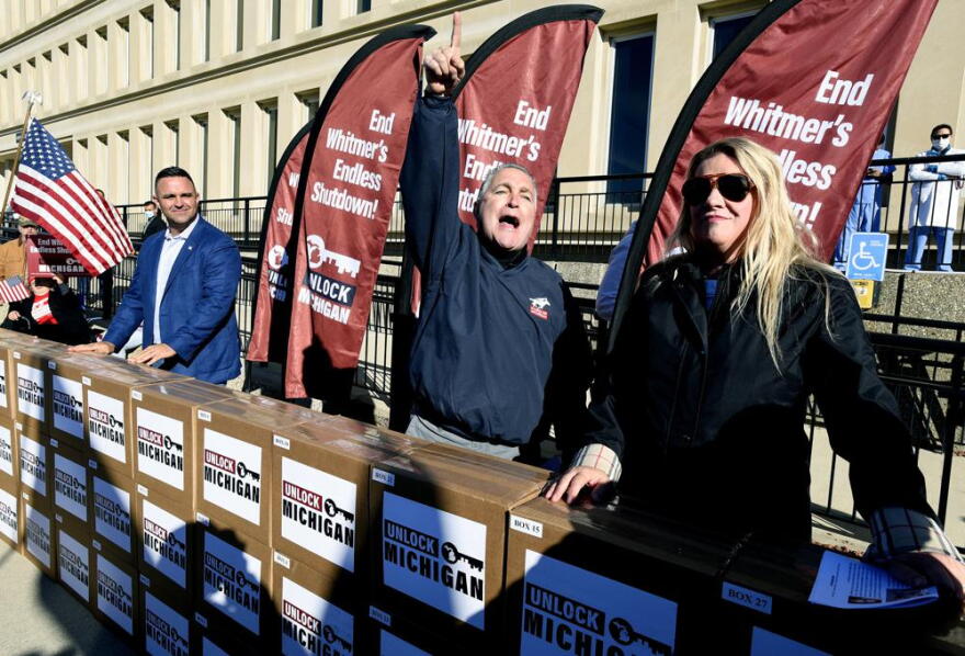 In this Oct. 2, 2020, file photo, Unlock Michigan Co-Chairs from left, Garrett Soldano, Ron Armstrong and Meshawn Maddock, speak to supporters in Lansing. Republican lawmakers on Wednesday, July 21, 2021, killed a law that underpinned coronavirus restrictions issued by Gov. Gretchen Whitmer in 2020, wiping it from the books after Michigan's Supreme Court declared the measure unconstitutional.