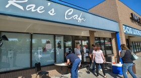 Customers sign in at the entrance of Rae's Cafe in Blue Springs to formalize their membership before entering the restaurant on Tuesday, Sept. 15.