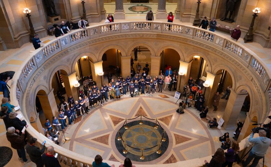 Children and parents from Annunciation School sing Feb. 24, 2026, inside the Capitol during a rally urging lawmakers to pass gun safety measures.