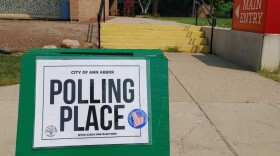 vote here and polling place signs line a street in Ann Arbor, Michigan