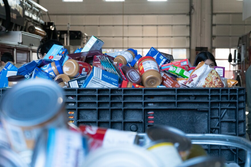 Non-perishable food items, like pasta and peanut butter, overflow bins at the local fire station in Clayton, Mo.