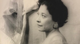 A black and white photo of a woman with short hair facing the left. 