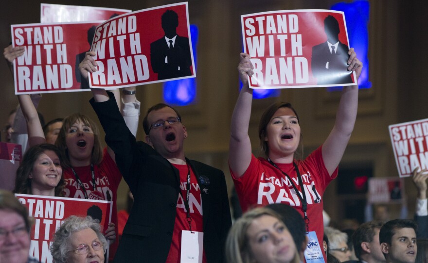 Supporters of Sen. Rand Paul cheer as he speaks during CPAC.