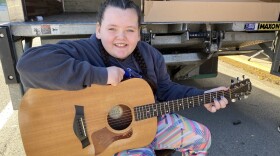 Kylee Ingram shows off the guitar she received at Knott County Central High School. She is learning to play and is happy.