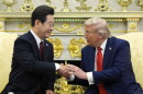 President Donald Trump, right, shakes the hand of South Korean President Lee Jae Myung during a meeting in the Oval Office of the White House, Monday, Aug. 25, 2025, in Washington. (AP Photo/Alex Brandon)