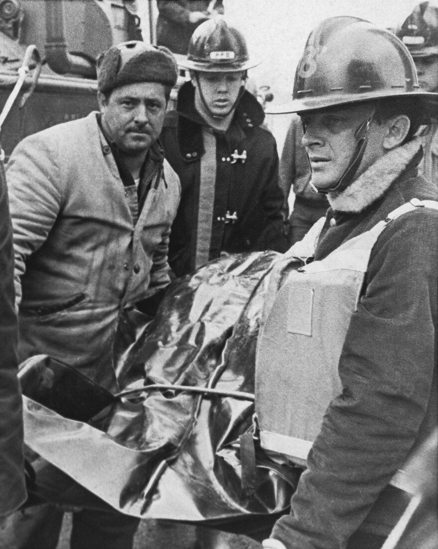 In this Dec. 15, 1967 photo, rescuers take a body to a temporary morgue in Point Pleasant, W.Va., after it was recovered from wreckage taken from the Ohio River where the Silver Bridge collapsed.