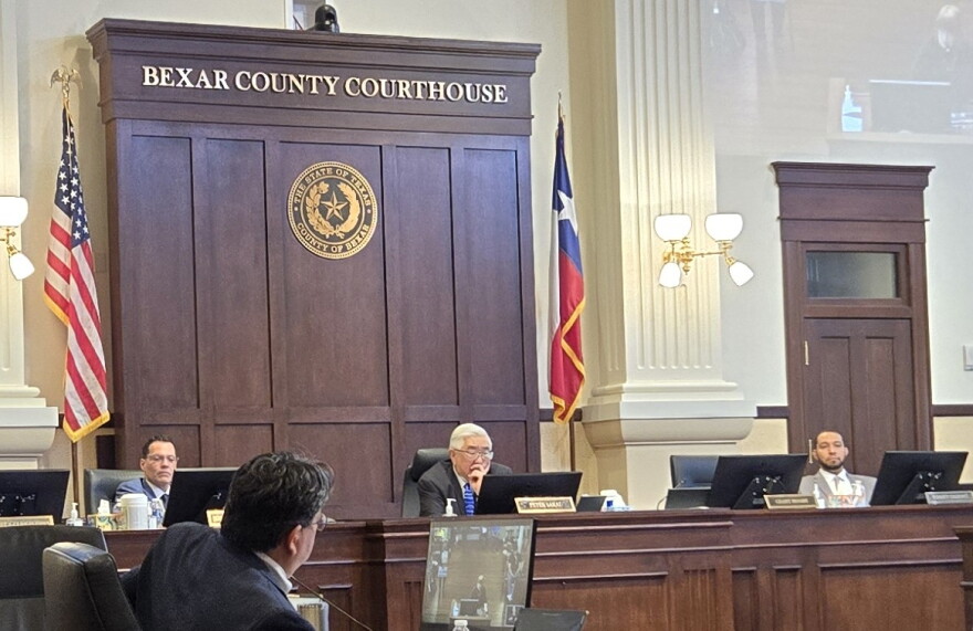 Bexar County Judge Peter Sakai, center, presides over county commissioners meeting at the county courthouse