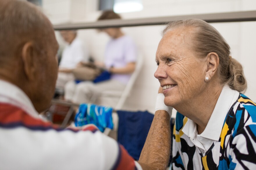 Janice Johnston sits with Graham after his races at the Cleveland State University Natatorium on Wednesday. She attends every one of his practices and races, cheering him on.