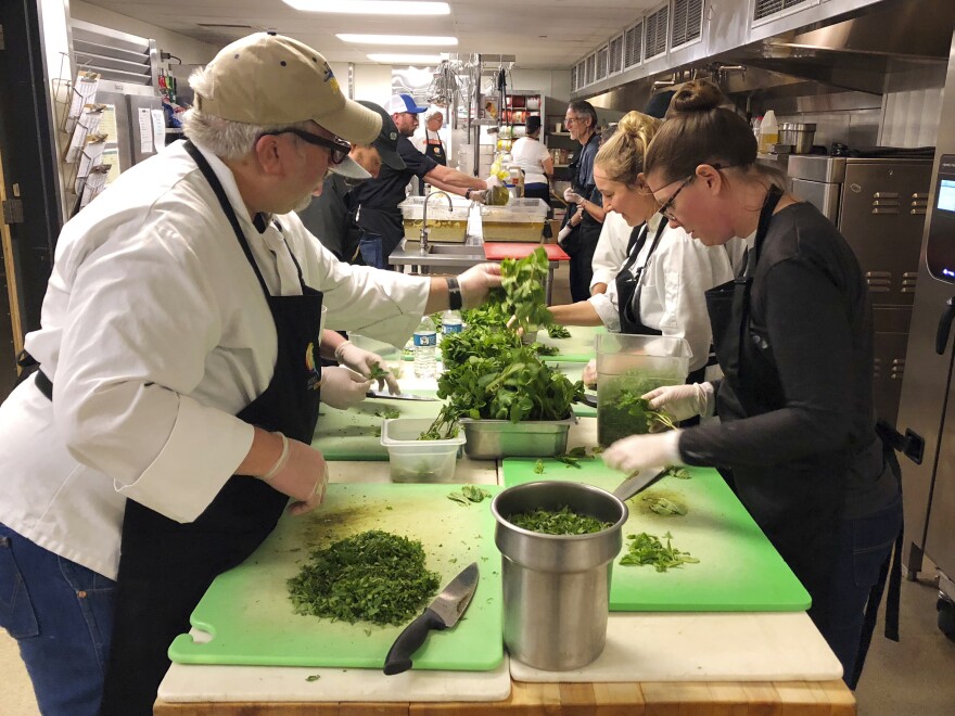 Volunteers prepare a community Thanksgiving meal for Camp Fire survivors Wednesday at California State University, Chico.