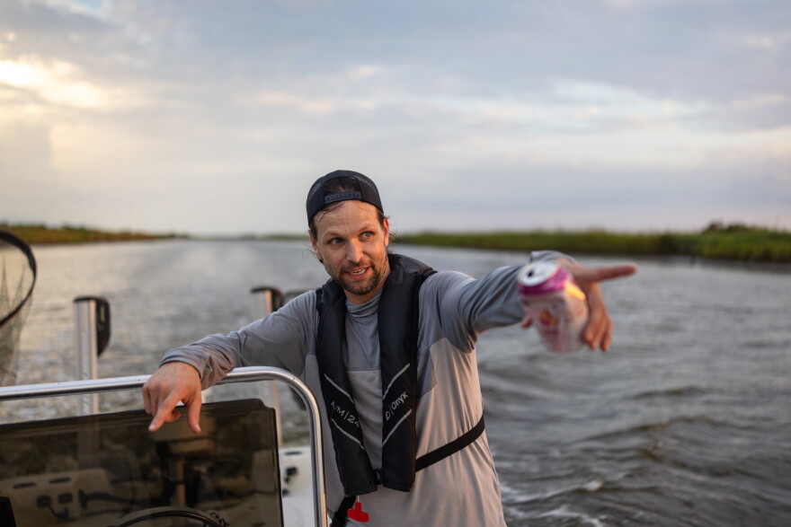 Gabe Giffin points to birds along the shoreline on Pecan Island in Vermilion Parish, Louisiana, on Tuesday, August 25, 2026. 