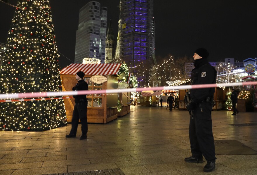 Police survey the area after someone rammed a truck into a crowded Christmas market in Berlin on Monday.