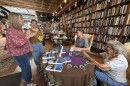 Brad Ryan and his grandmother Joy Ryan sign copies of his book while sitting at a table for fans during an book store signing. 