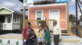The Diaz' smile in front of their new Key West style home. (Lauren Reynolds/WUFT News)