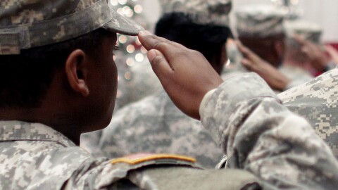 In this Wednesday Dec. 5, 2012, file photo, soldiers salute the U.S. flag during the Pledge of Allegiance at a welcome home ceremony for soldiers returning from a deployment in Afghanistan, at Fort. Carson, Colo. For veterans, the GI Bill can be the ticket to a debt-free college education.