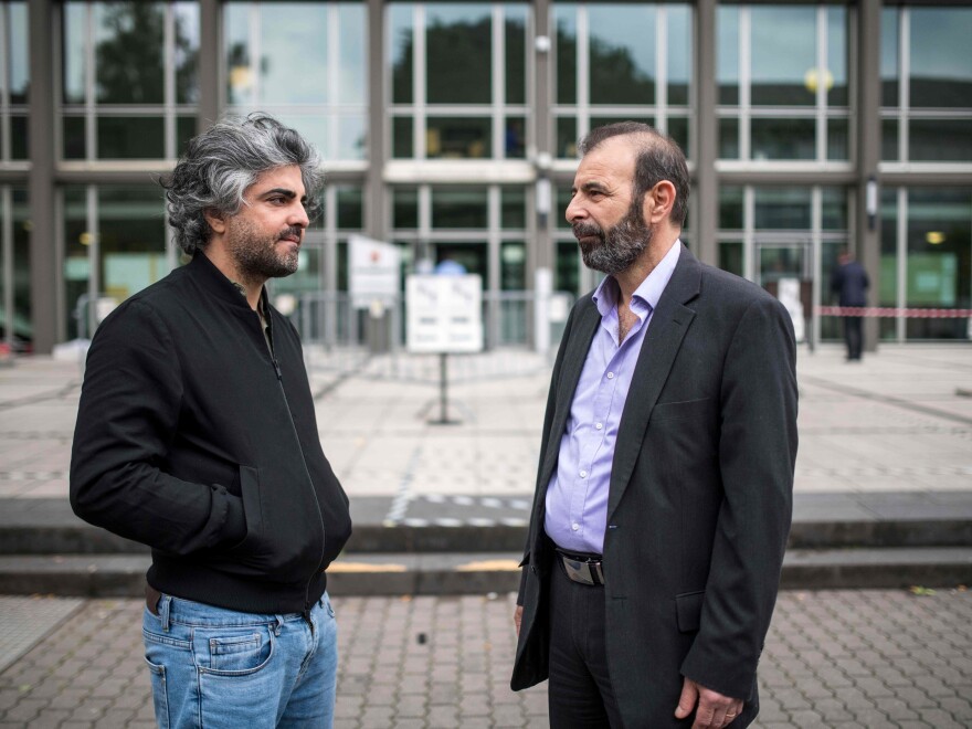 Fayyad (left) and Syrian human rights lawyer Anwar al-Bunni are seen outside the trial against two Syrian alleged former intelligence officers accused for crimes against humanity on June 4 in Koblenz, Germany.